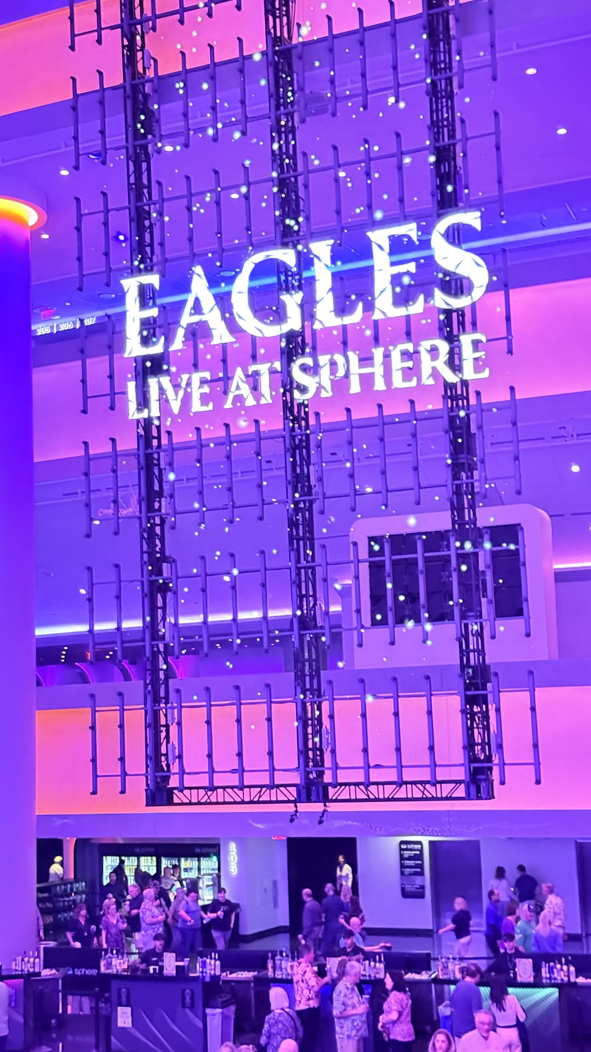 Sphere atrium in purple light with the EAGLES LIVE AT SPHERE sign
