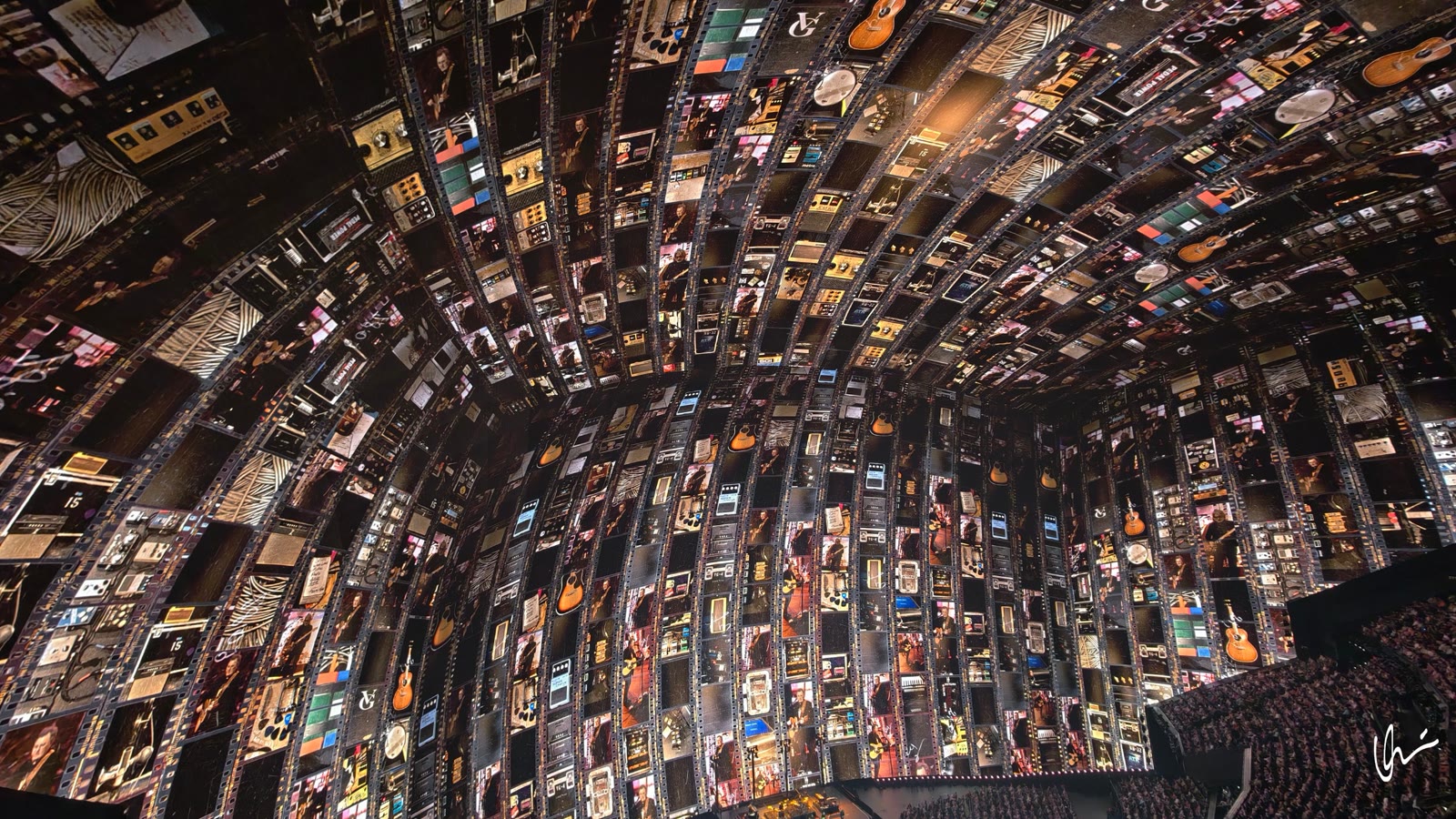 Close-up of the dome projection: guitars, effect pedals, amplifiers and archive photos of the band