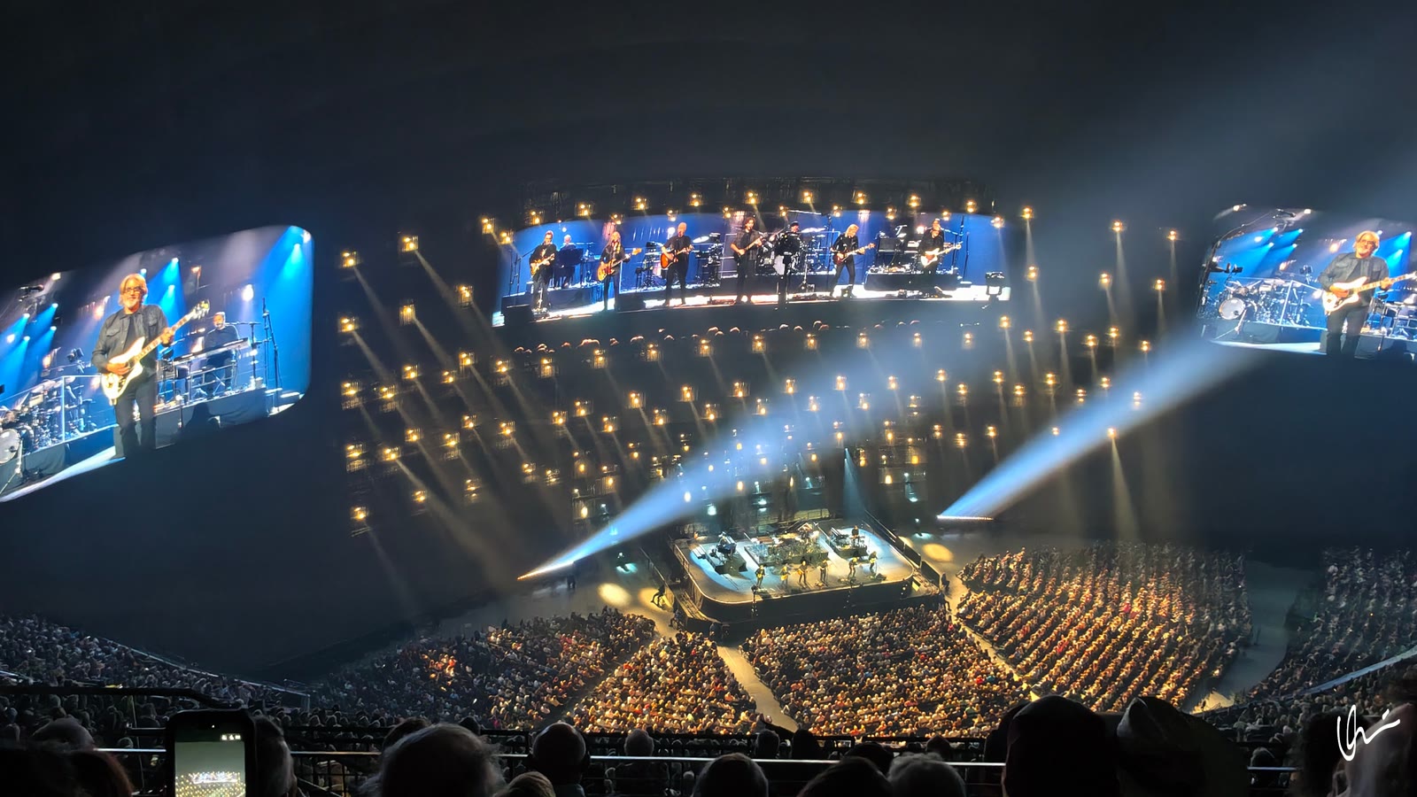 Eagles on stage: musicians close-up on the giant dome screens, hall in blue light